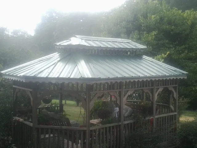 Two tier green metal roof on a garden gazebo in Mercer Island